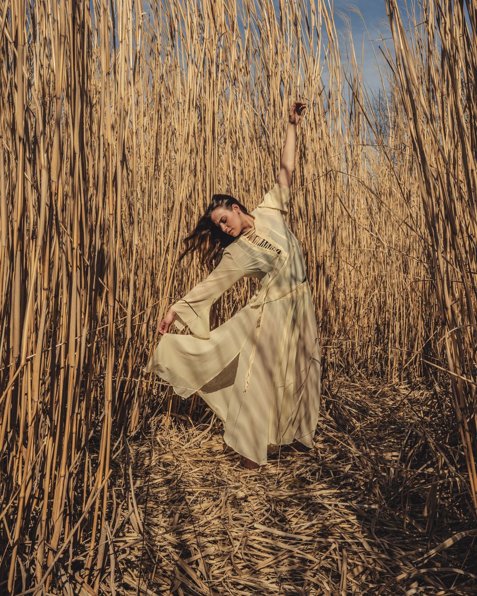 Portrait dancing in tall grass field